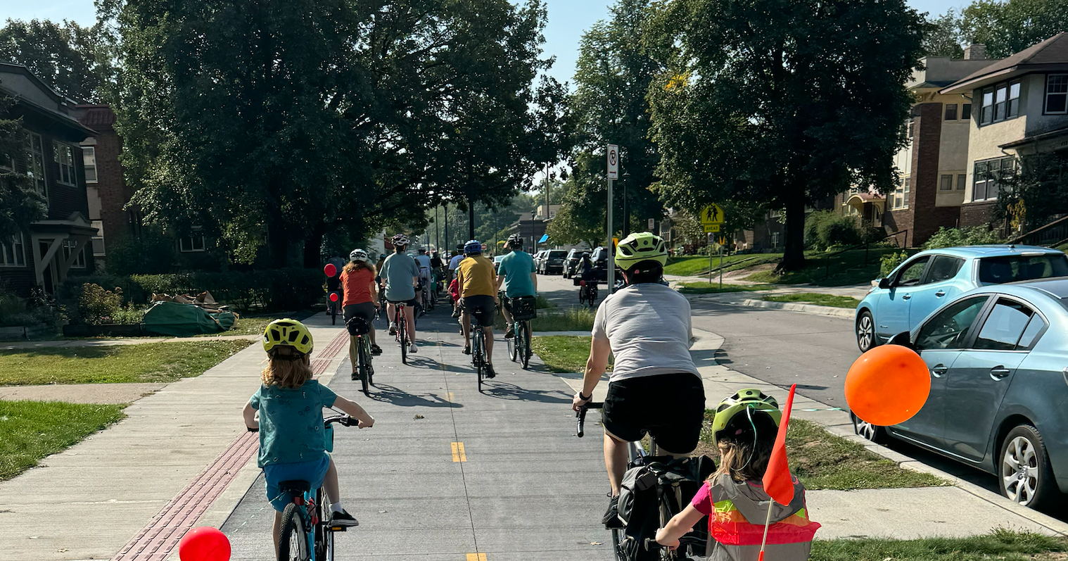 families bike along the protected Bryant Ave Bikeway