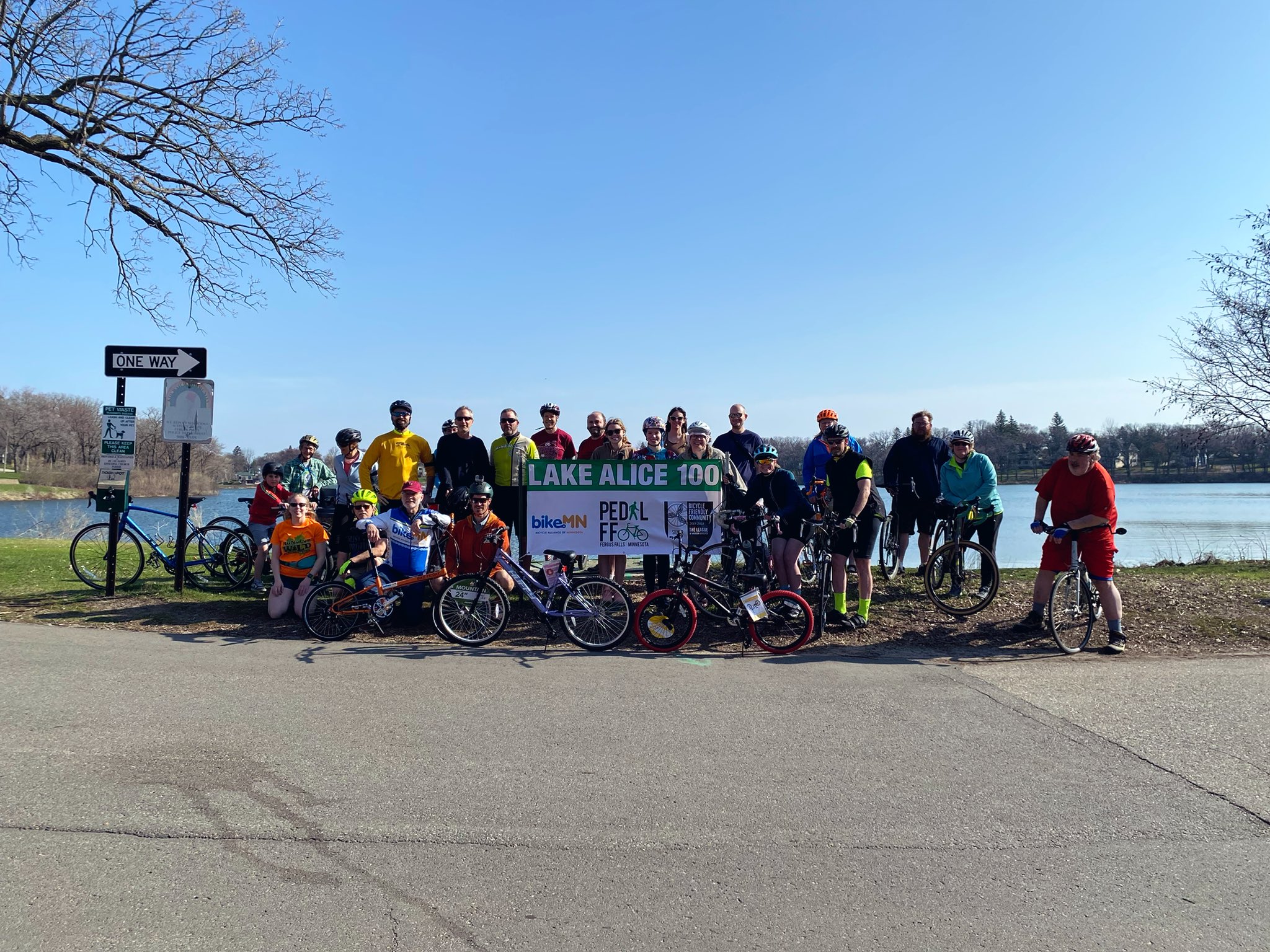 A group of over 15 people gather for a photo during the Lake Alice 100