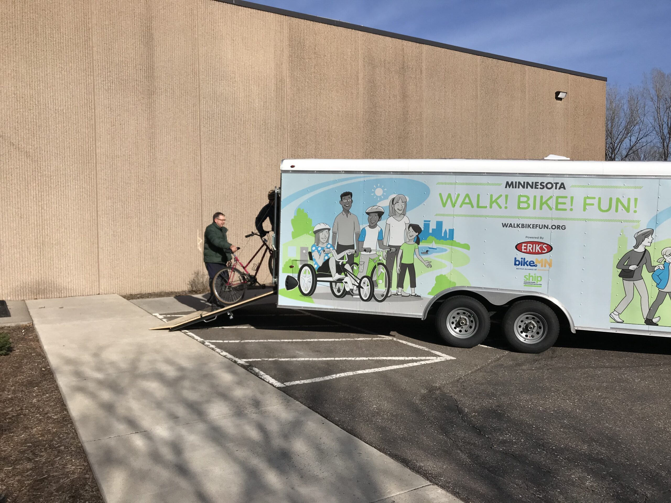 More bikes are loaded into the back of the BikeMN trailer